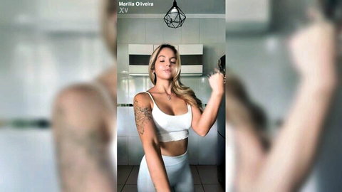 Blonde Marilia Oliveira teases curves in white crop top and leggings