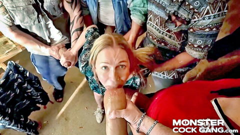 Blonde woman surrounded by men in monster cock gangbang oral scene