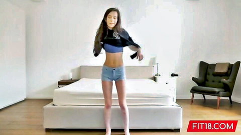 Skinny Ariel Grace posing in cropped blue hoodie and denim shorts