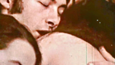 Vintage gay porn thumbnail: two men in close embrace, classic Moon Films scene