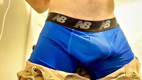 Hairy muscular guy pulls down jacket revealing huge cock bulge in tight blue NB underwear mirror selfie