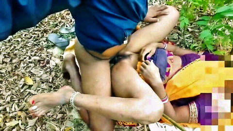 Indian man in blue shorts fucks saree-clad woman's exposed pussy outdoors in jungle