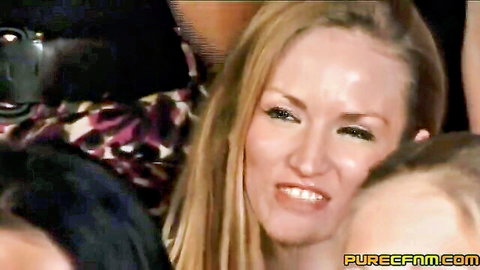 Smirking blonde CFNM babe eyes guy in crowded clothed female naked male party