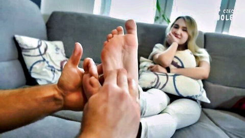 Blonde woman's bare feet worshiped in foot fetish massage POV