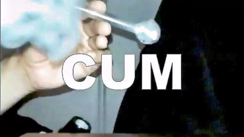 Hand holding spoon overflowing with thick dripping cum semen closeup