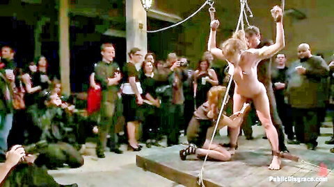 Blonde Ass Queen bound nude in public humiliation party with crowd