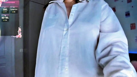 Petite teen with small perky tits exposes bare boobs in open white shirt