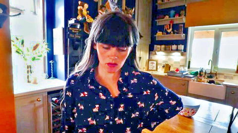 Brunette MILF in floral blouse leans over kitchen table with open mouth POV tease