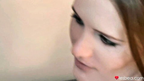 Seductive redhead teen close-up with sultry gaze in lesbian sensual video