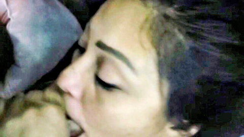 Asian woman lying on back sucking penis in close-up blowjob to facial cumshot