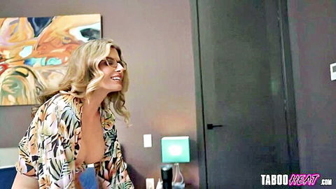 Blonde beauty in open floral kimono revealing cleavage, smiling seductively