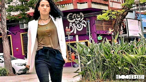 Lady Snow in chic white blazer and black pants, curly brunette outdoors