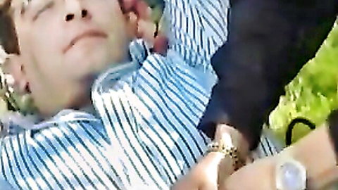 90s French granny scene: mature man lying relaxed in striped shirt outdoors