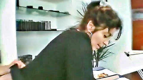 Brunette MILF bent over as young guy touches her from behind