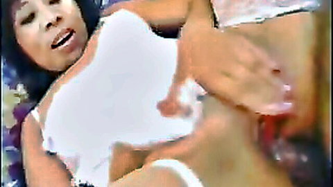 Mature Asian woman in white top, legs spread, intense vaginal penetration