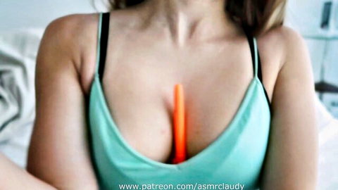 ASMR Claudy in teal sports bra with orange stick in deep cleavage