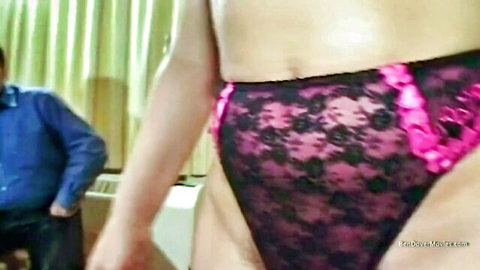 Close-up of woman in sexy pink lace panties teasing crotch with man in background