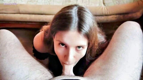 POV closeup of brunette sucking thick cock base with intense eye contact on couch