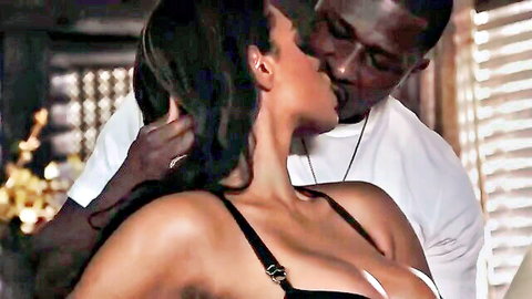 Busty ebony woman in lacy bra kissing muscular black man passionately