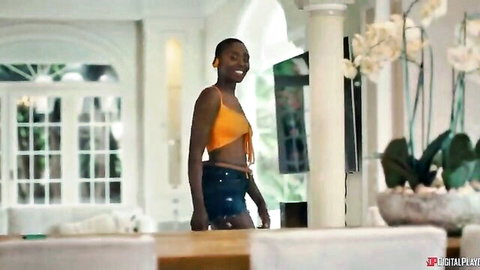 Zaawaadi in sexy orange crop top and denim shorts, fit ebony model posing