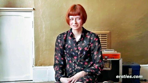 Redhead with glasses in floral blouse teases in first solo video
