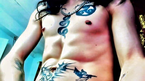 Atheneo muscular tattooed man with long hair showing toned abs and chest