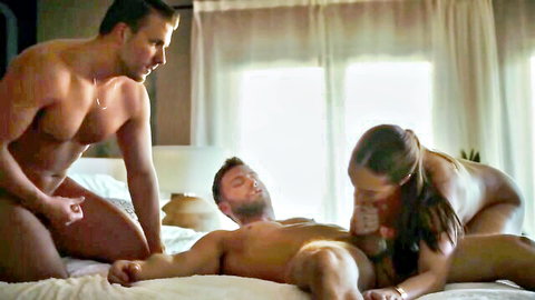 Brunette MILF in nude MMF threesome strokes big cock while muscular stud gropes her ass on bed