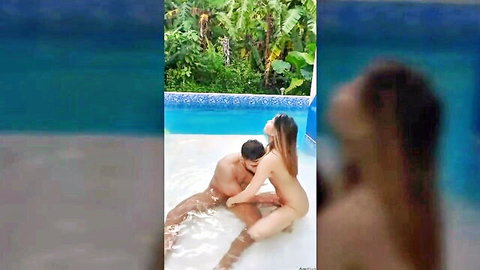 Naked South Asian woman rides man's cock in outdoor pool with tropical plants