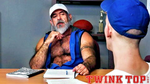 Hairy bearded daddy confronts young shaved-head twink athlete in tank tops