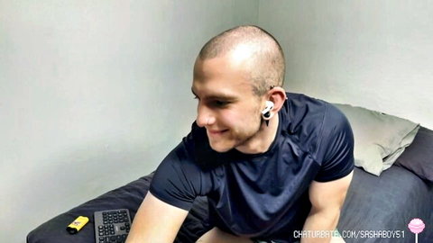 Sashaboy51 bald muscular jock smiling in tank top, gay webcam tease