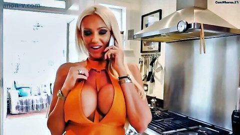 Busty blonde Lucy Zara in revealing orange dress on phone