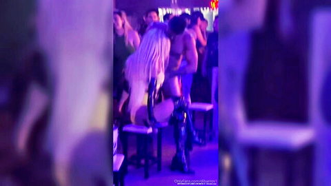 Blonde woman in lingerie enjoys lap dance from muscular male stripper