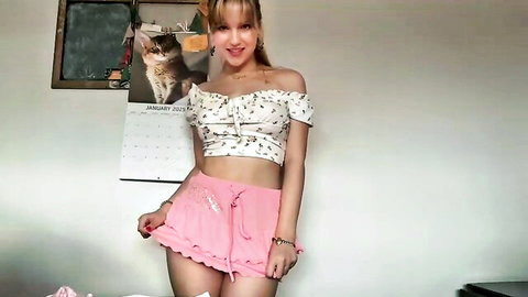 kittengirlxo posing in white off-shoulder crop top and pink mini skirt