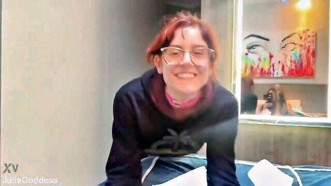Smiling redhead with glasses in posh vixen adult teaser, thrilling vibe