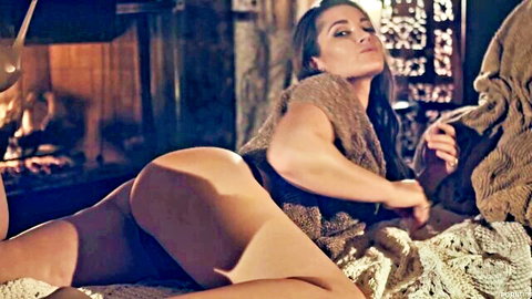 Dani Daniels in sexy lingerie lounging seductively by fireplace