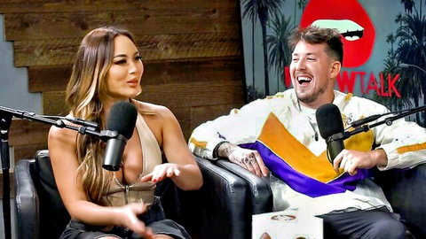 Busty babe in skimpy halter top showing deep cleavage laughs with tattooed hunk on WTF Talk podcast