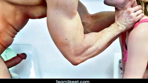 Muscular stud grabs skinny blonde's neck while his thick erect cock dangles nearby