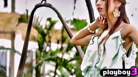 Slim Gloria Sol in green dress showing off perfect body on swing