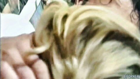 Blonde curly-haired MILF with glasses in intimate hair-touch moment