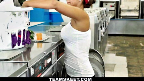 Latina teen in tight white tank top bending over laundry in laundromat