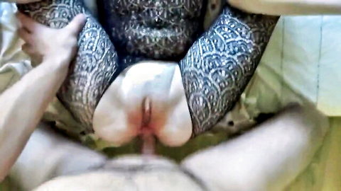 Tattooed woman's spread pussy and ass exposed as hard cock penetrates her wet slit closeup