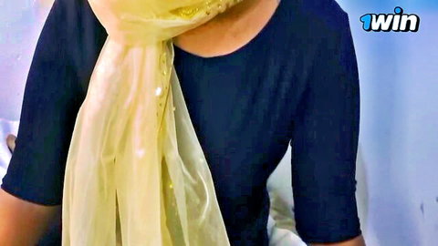 Thai woman in sheer yellow scarf and black top teases with oral promise