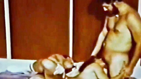 Vintage bestiality: hairy man stands as dogs lick nude woman's pussy