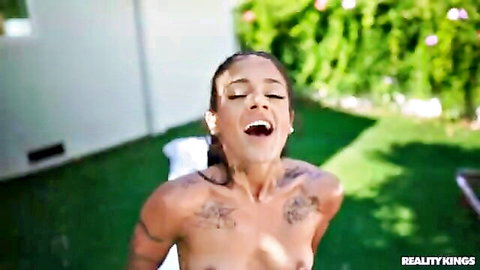Ryan Reid nude ebony beauty laughing with tattoos and water outdoors