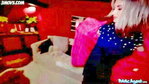 Blonde MILF in sparkling blue top holding pink robe in red casting room