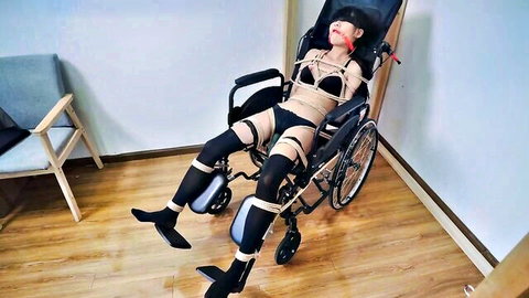Bound Asian woman in lingerie endures machine-induced multiple orgasms in wheelchair
