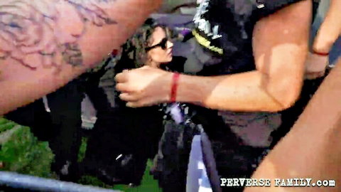 Lesbian grab at Perverse Rock Fest with curly-haired woman in black