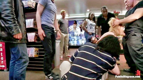 Blonde woman humiliated and grabbed by group of men in public store