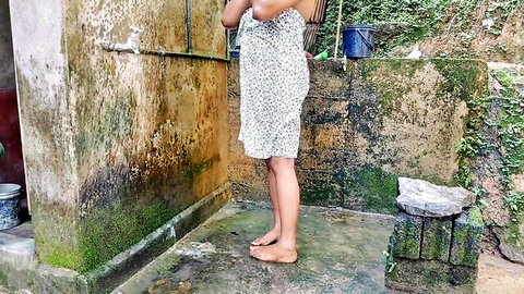 Amateur South Asian woman in wet floral dress showering outdoors teasing curves and bare feet