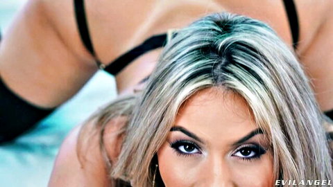 Hot blonde bombshell in black lingerie gives intense POV stare from pool with tanned babe's ass behind